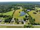 Aerial view outlining property lines, buildings, pond, and surrounding greenery and structures for a comprehensive perspective at 2637 S Nc 87, Graham, NC 27253