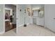 Open bathroom featuring vanity, makeup table, large mirror, tile floor, and natural light at 2637 S Nc 87, Graham, NC 27253