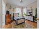 Cozy bedroom with natural light, hardwood floors, and neutral wall colors at 2637 S Nc 87, Graham, NC 27253