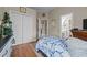 Bedroom featuring hardwood floors, a double door closet, and views into the bathroom at 2637 S Nc 87, Graham, NC 27253