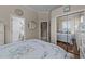 Cozy bedroom featuring a mirrored closet, a round mirror, and access to the attached bathroom at 2637 S Nc 87, Graham, NC 27253