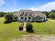 Charming home featuring stone accents, dormer windows, rocking chair front porch and lush landscaping on a well manicured lawn at 2637 S Nc 87, Graham, NC 27253