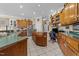 Well-lit kitchen with wooden cabinets, stainless steel appliances, and a center island at 2637 S Nc 87, Graham, NC 27253