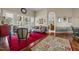 Cozy living room with large windows, hardwood floors, decorative rugs, and comfortable seating at 2637 S Nc 87, Graham, NC 27253