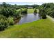 A beautiful view of a house overlooking a large pond, surrounded by lush green grass and trees at 2637 S Nc 87, Graham, NC 27253