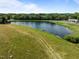 Scenic view of a beautiful pond surrounded by lush greenery and a clear blue sky at 2637 S Nc 87, Graham, NC 27253