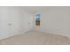 Bedroom with neutral carpet, large window, and a closet at 30 Chloe Ct, Selma, NC 27576