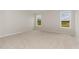 Bright bedroom with neutral carpet, two windows, and ample natural light at 30 Chloe Ct, Selma, NC 27576