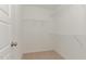 Walk-in closet featuring wire shelving and neutral carpeting at 30 Chloe Ct, Selma, NC 27576