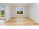 Inviting dining area with wood flooring, ample natural light, and a modern chandelier at 30 Chloe Ct, Selma, NC 27576
