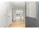 Bright entryway with wood floors, white walls, and a view into the sun-lit living spaces at 30 Chloe Ct, Selma, NC 27576