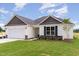 Charming single-story home showcasing a well-maintained lawn and stylish stone detailing at 30 Chloe Ct, Selma, NC 27576