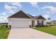 Lovely single-story home with a spacious two-car garage, green lawn, and attractive stone accents at 30 Chloe Ct, Selma, NC 27576