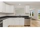 Well-lit kitchen featuring white cabinets, stainless steel dishwasher, and modern countertops at 30 Chloe Ct, Selma, NC 27576