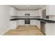 Bright kitchen showcasing white cabinetry, stainless steel appliances, and hardwood flooring at 30 Chloe Ct, Selma, NC 27576