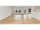 Sunlit living room showcasing wood flooring, large windows, and an open-concept design at 30 Chloe Ct, Selma, NC 27576