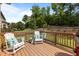 Relaxing back deck with comfortable seating, rocking chairs, and a view of the lush green yard at 3032 Curling Creek Drive Dr, Apex, NC 27502