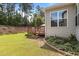 Inviting backyard featuring a wooden deck, lush green grass, and mature trees offering shade and privacy at 3032 Curling Creek Drive Dr, Apex, NC 27502