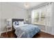 Charming bedroom with hardwood floors, neutral walls, and bright natural light streaming through the window at 3032 Curling Creek Drive Dr, Apex, NC 27502