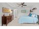 Comfortable bedroom featuring a blue quilt and wooden furniture, with doorways leading to other rooms at 3032 Curling Creek Drive Dr, Apex, NC 27502