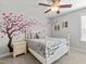 Comfortable bedroom featuring a ceiling fan, a charming white bed frame and a cherry blossom decal at 3032 Curling Creek Drive Dr, Apex, NC 27502