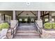 Exterior entrance into clubhouse with stone pillars, steps, and views into large meeting hall at 3032 Curling Creek Drive Dr, Apex, NC 27502