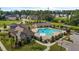 Aerial view of a pristine community pool area with lounge chairs, a pool house, and lush landscaping at 3032 Curling Creek Drive Dr, Apex, NC 27502