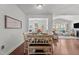 Dining area with a set table, open to the living room with a fireplace, and a view to the backyard at 3032 Curling Creek Drive Dr, Apex, NC 27502