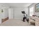 Bright exercise room with a stationary bike, an open doorway, and a desk area for a balanced lifestyle at 3032 Curling Creek Drive Dr, Apex, NC 27502