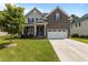 Charming brick and siding two-story home with a well-manicured lawn and a two-car garage at 3032 Curling Creek Drive Dr, Apex, NC 27502