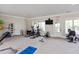 Community fitness center with treadmills, exercise equipment, and a wall-mounted television at 3032 Curling Creek Drive Dr, Apex, NC 27502