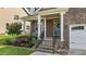 Inviting front porch with brick steps, white columns, and a beautifully landscaped garden at 3032 Curling Creek Drive Dr, Apex, NC 27502