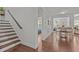 Hallway leading to a dining area with stairs, showcasing an open and airy layout at 3032 Curling Creek Drive Dr, Apex, NC 27502