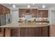 Gourmet kitchen featuring a large center island with bar seating, stainless steel appliances, and custom cabinetry at 3032 Curling Creek Drive Dr, Apex, NC 27502