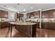 Spacious kitchen featuring a large center island, modern appliances, and dark wood cabinets at 3032 Curling Creek Drive Dr, Apex, NC 27502