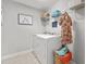 Functional laundry room with washer, dryer, and ample storage shelving, blending utility with style at 3032 Curling Creek Drive Dr, Apex, NC 27502