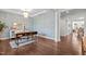 Stylish sitting room featuring unique wallpaper, hardwood floors, and a modern table at 3032 Curling Creek Drive Dr, Apex, NC 27502