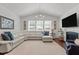 Bright living room boasts vaulted ceilings, large windows, and a cozy fireplace at 3032 Curling Creek Drive Dr, Apex, NC 27502