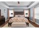 Stately main bedroom with tray ceiling, lots of natural light, and carved decorative wood headboard at 3032 Curling Creek Drive Dr, Apex, NC 27502