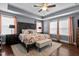 Spacious main bedroom with a tray ceiling, hardwood floors, and a decorative carved wood headboard at 3032 Curling Creek Drive Dr, Apex, NC 27502