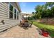 Cozy backyard patio featuring a dining set under an umbrella, perfect for outdoor entertaining at 3032 Curling Creek Drive Dr, Apex, NC 27502