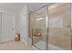 Well-lit bathroom featuring a glass enclosed tiled shower stall, plus a door leading to the toilet at 3032 Curling Creek Drive Dr, Apex, NC 27502