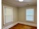 Bedroom featuring hardwood floors and two windows with white blinds at 306 Penny St, Garner, NC 27529