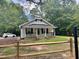 Charming exterior of a white cottage-style home with a inviting front porch at 306 Penny St, Garner, NC 27529