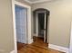 Hallway with hardwood floors and arched doorways leading to other rooms at 306 Penny St, Garner, NC 27529