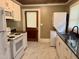 Kitchen with stainless steel appliances, granite countertops, and a stacked washer and dryer at 306 Penny St, Garner, NC 27529