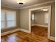 Bright living room with windows, hardwood floors, and a view of adjoining rooms at 306 Penny St, Garner, NC 27529