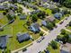 Aerial view of a charming two-story home with well-maintained lawn surrounded by other homes and lush greenery at 3101 Riverbrooke Dr, Raleigh, NC 27610