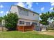 View of home's rear exterior with a wooden deck and large grassy lawn at 3101 Riverbrooke Dr, Raleigh, NC 27610