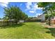 A large backyard with a green lawn, a utility shed, and mature trees at 3101 Riverbrooke Dr, Raleigh, NC 27610